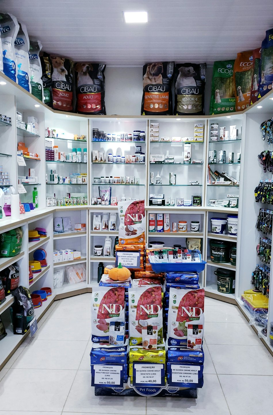 Brightly lit pet store interior with shelves of pet supplies.